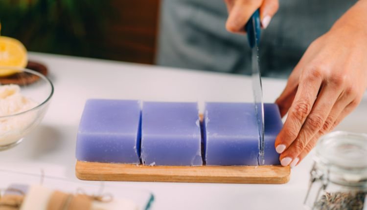 Cutting homemade soap into bars for laundry use.