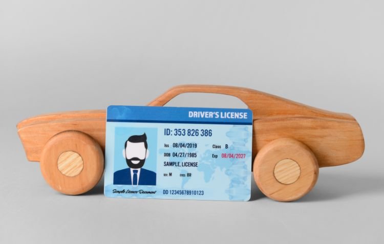 How Long Does It Take to Get a CDL? License next to a wooden car.