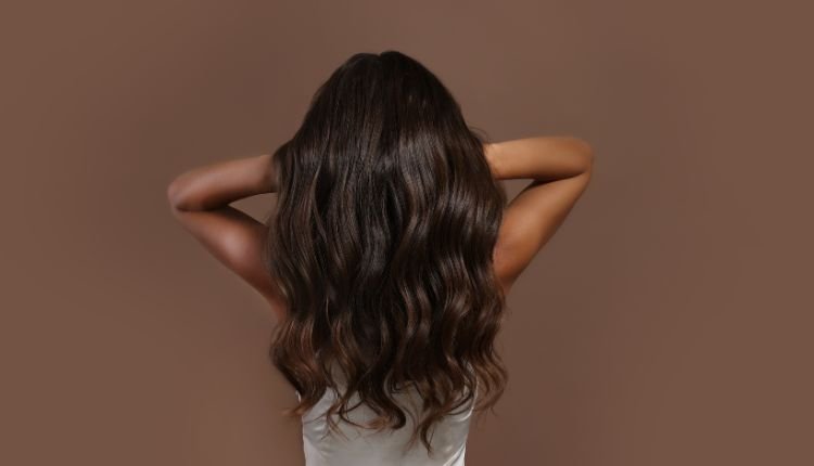 Long, shiny, wavy hair with a smooth, healthy appearance.