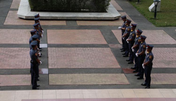 Police officers standing in formation during academy training.