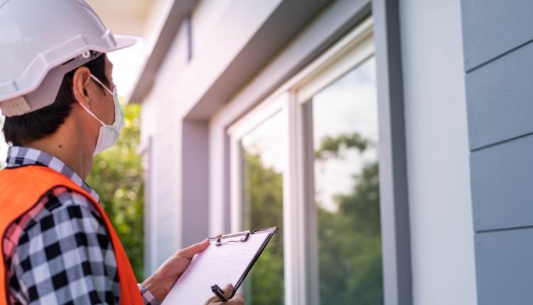 Home inspector assessing a house exterior