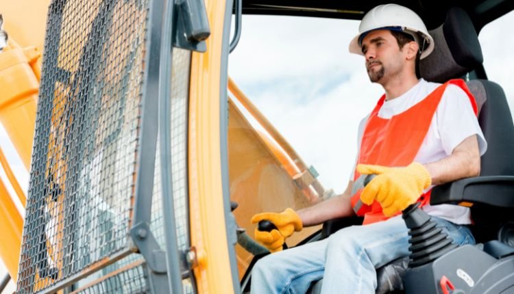 Construction worker operating a heavy-duty crane.