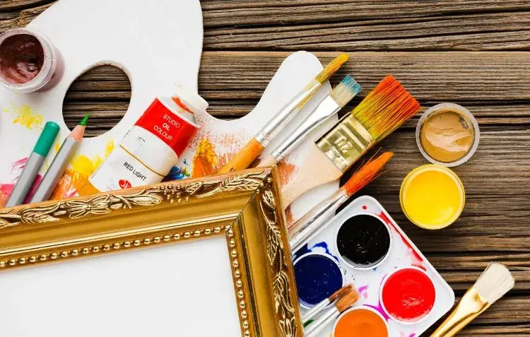 Oil paint supplies with brushes, palette, and canvas.