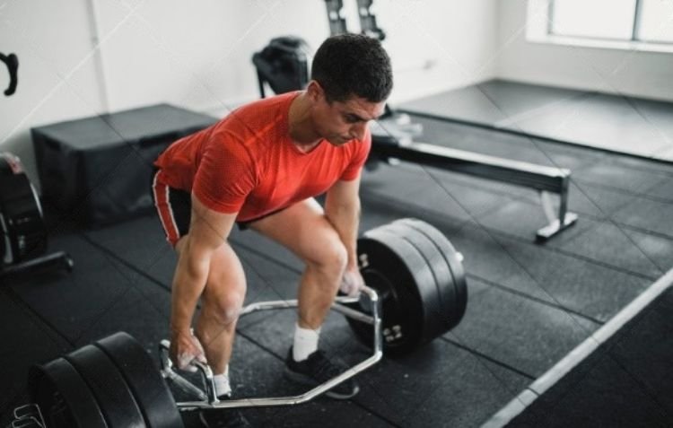 How Much Does a Trap Bar Weigh? Man lifting a trap bar.