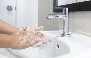 Washing hands with soap to remove odors like gas.